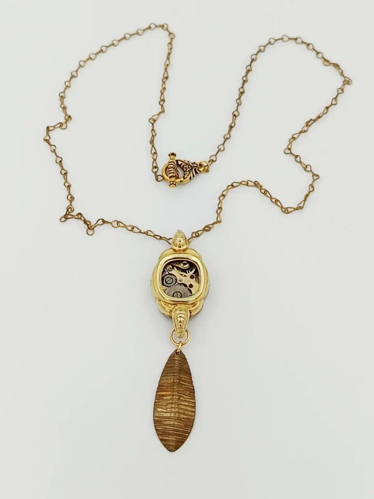 Collier or bronze mouvement montre rubis